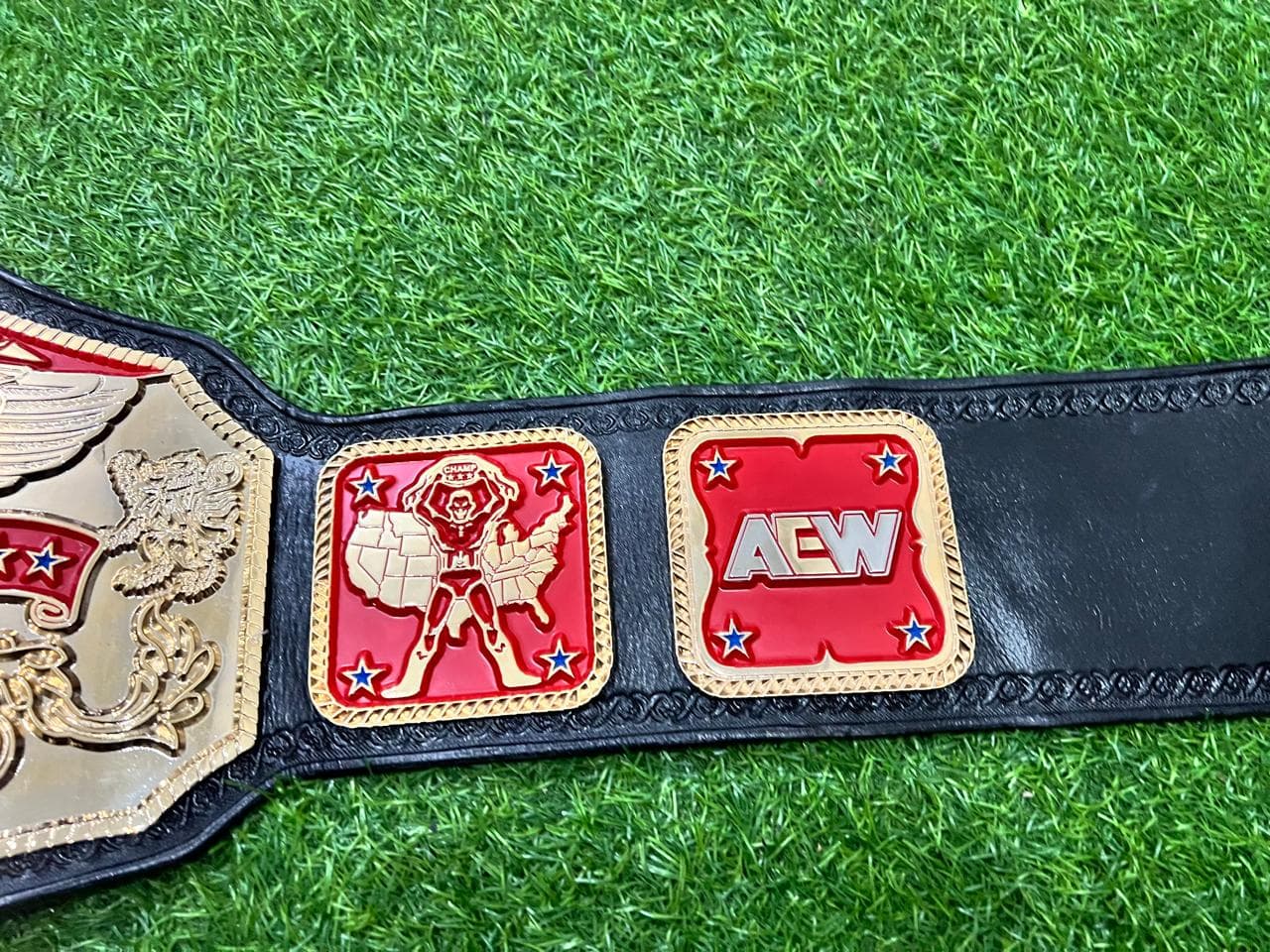 National Eagle Championship Belt laid flat, showing the centre plate and side plates on a black leather strap