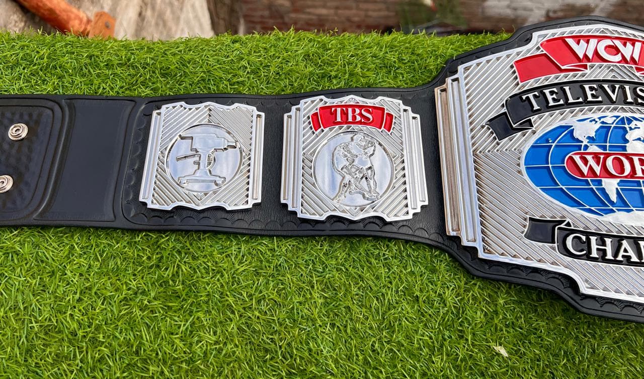 Television Champion Silver Championship Belt laid flat, showing the centre plate and side plates on a black leather strap