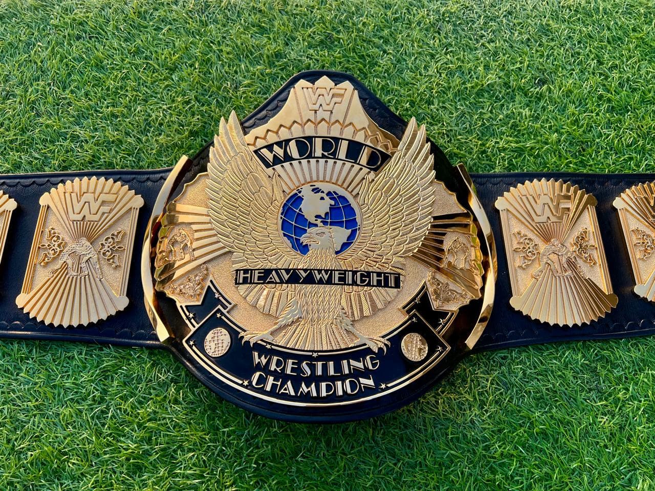 Winged Eagle Style Championship Belt laid flat, showing the centre plate and side plates on a black leather strap